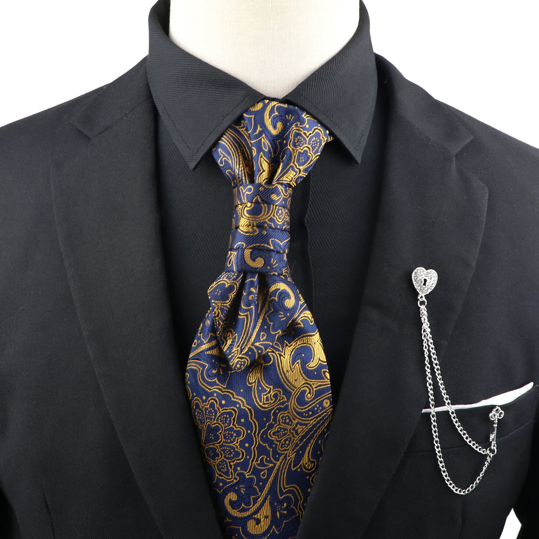 Mannequin wearing a black suit with a blue and gold paisley tie and a silver pocket knife on a white background