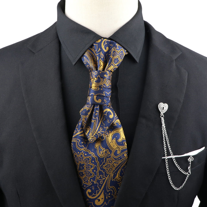 Mannequin wearing a black suit with a blue and gold paisley tie and a silver pocket knife on a white background