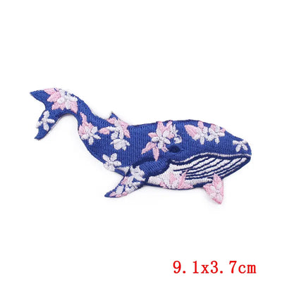 Floral-patterned whale-shaped patch on a white background with size label '9.1x3.7cm'.