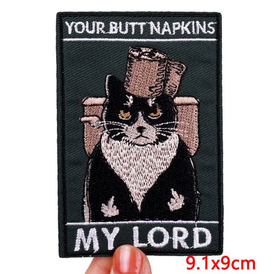 Embroidered patch with a cat in a top hat and monocle, labeled 'Your Butt Napkins My Lord'.