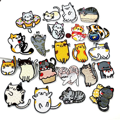Collection of various cat-themed patches on a white background