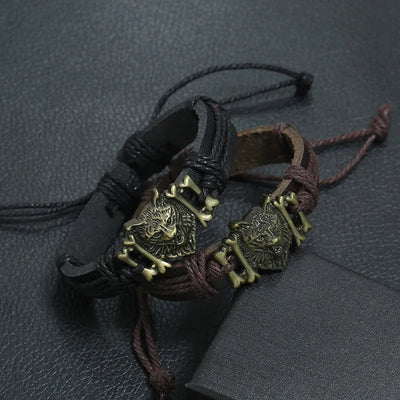 Bracelets with wolf head designs on a textured surface