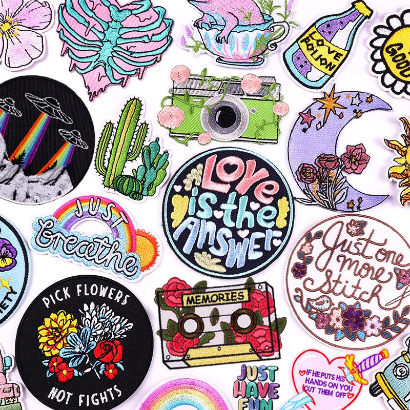 Collection of colorful patches with various designs and text on a white background