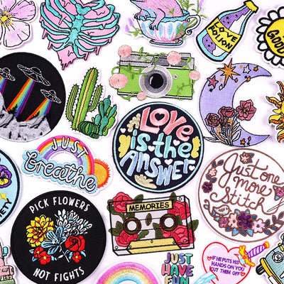 Collection of colorful patches with various designs and text on a white background
