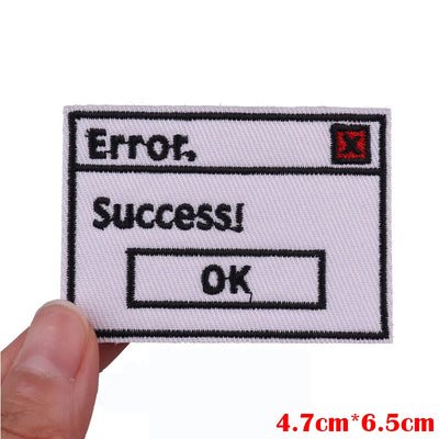 Embroidered patch with 'Error' and 'Success!' text on a white background