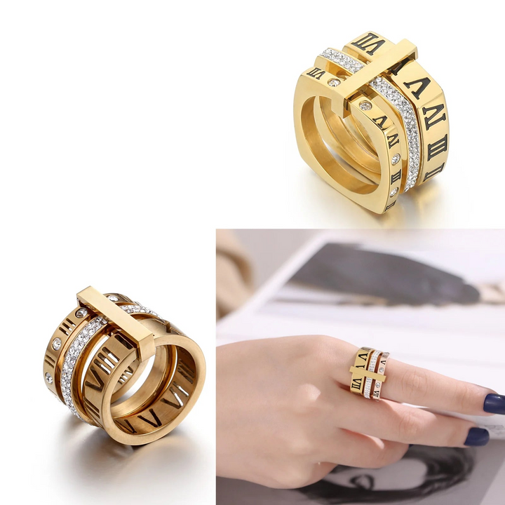 Gold rings with Roman numeral design on a white background, featuring the brand &