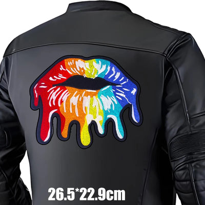 Black leather jacket with a colorful lips design on the back, size indicated.