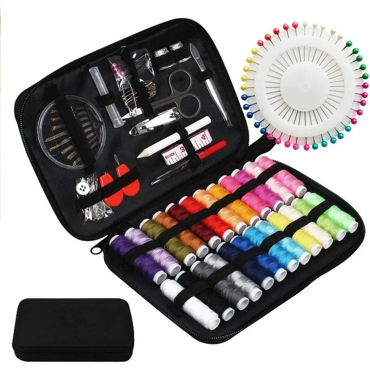 Sewing kit with threads, pins, and tools in a black case on a white background