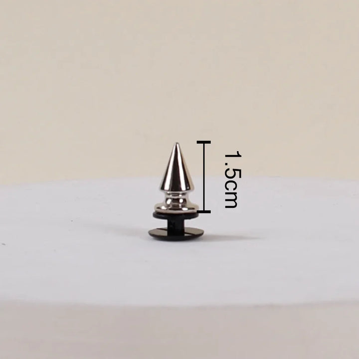 Metallic cone-shaped object with measurement label on a beige background