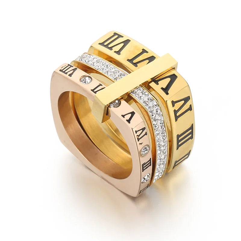 Gold ring with Roman numeral design on a white background