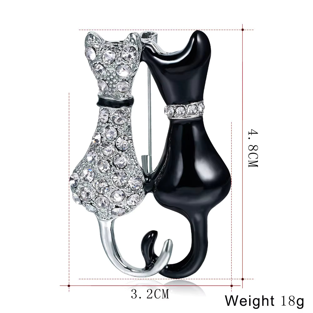 Cat-shaped brooch with crystal details, shown with measurements on a white background