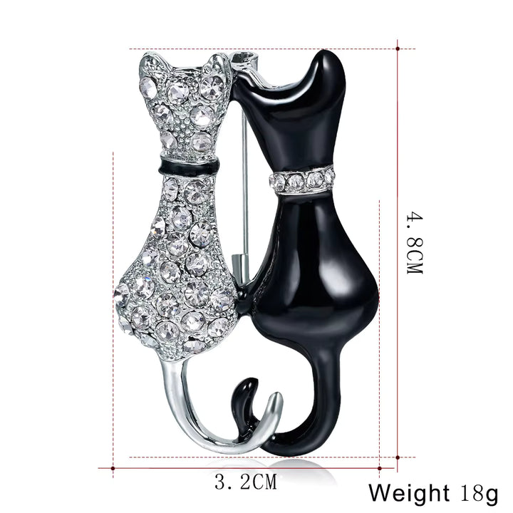 Cat-shaped brooch with crystal details, shown with measurements on a white background