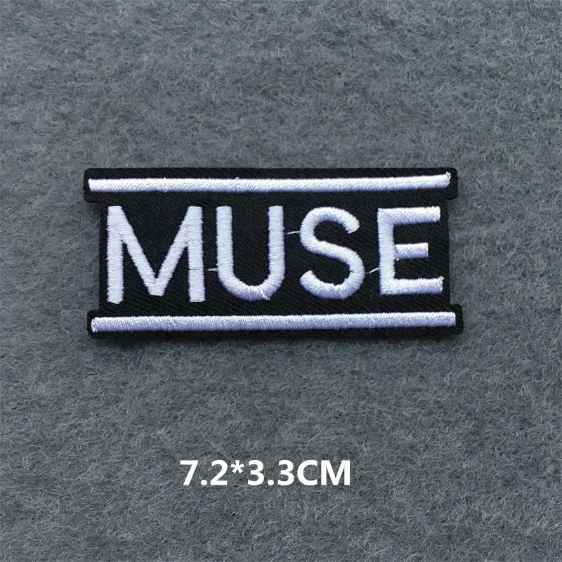Embroidered patch with 'MUSE' text on a gray background