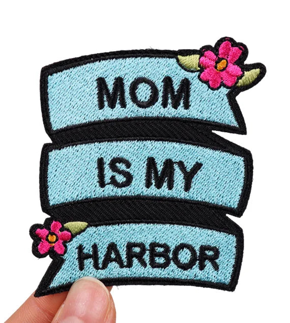 Embroidered patch with 'Mom is my harbor' text and flowers on a light blue background