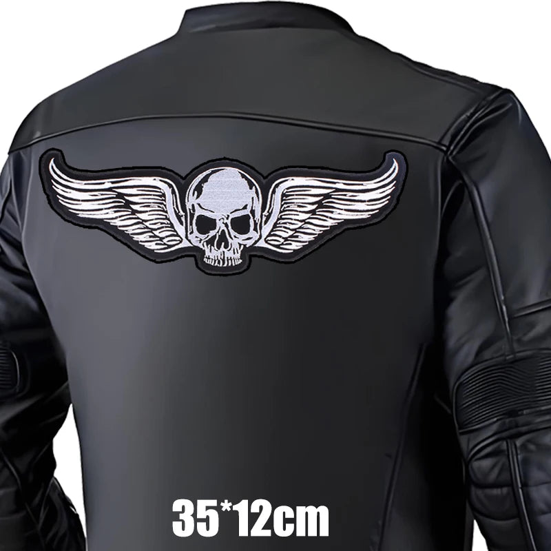Black leather jacket with a skull and wings design on the back, on a white background.