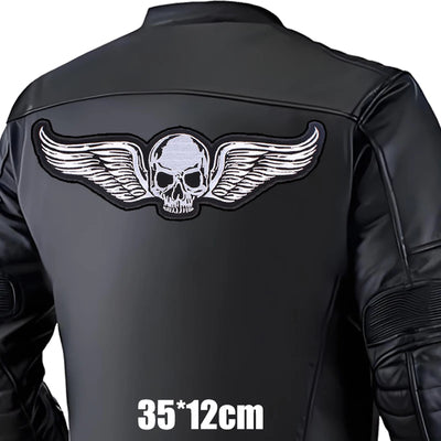 Black leather jacket with a skull and wings design on the back, on a white background.