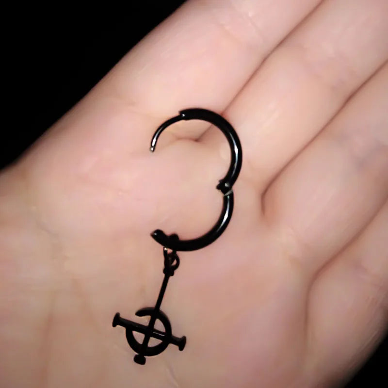 Black earring with a design on a hand