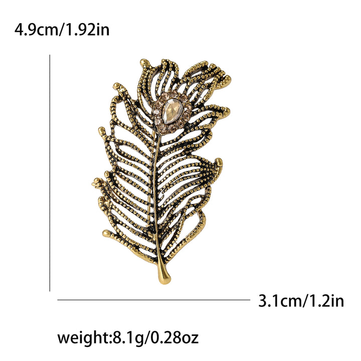 Gold feather-shaped brooch with measurements and weight displayed on a white background