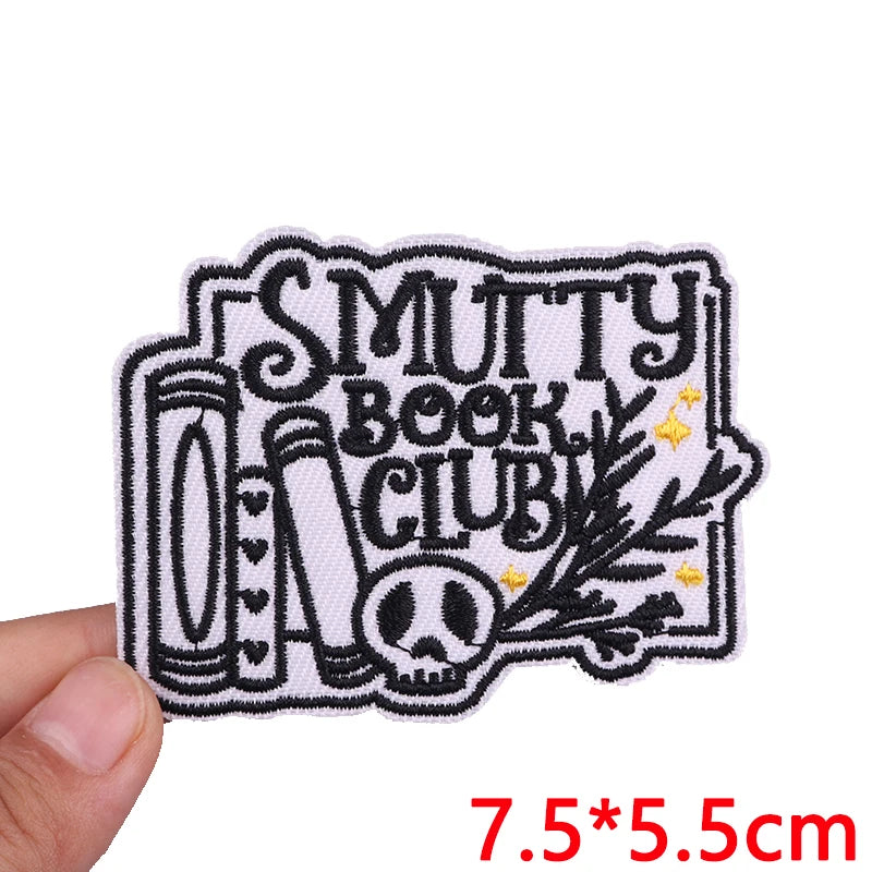 Patch with 'Smutty Book Club' design held by a hand, size 7.5*5.5cm