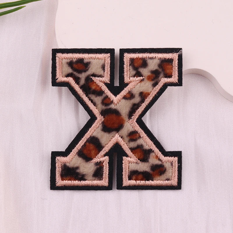 Leopard print letter 'X' patch on a white background