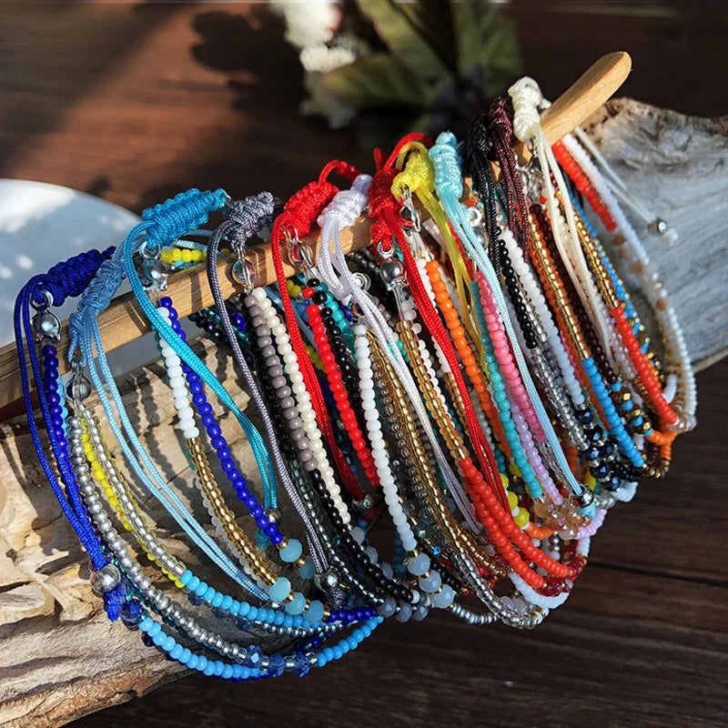 Colorful beaded bracelets on a wooden surface