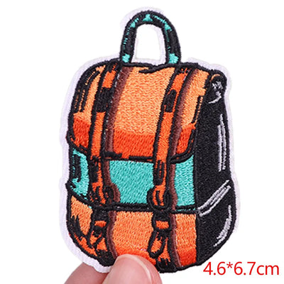 Colorful backpack patch held by a hand with dimensions indicated.