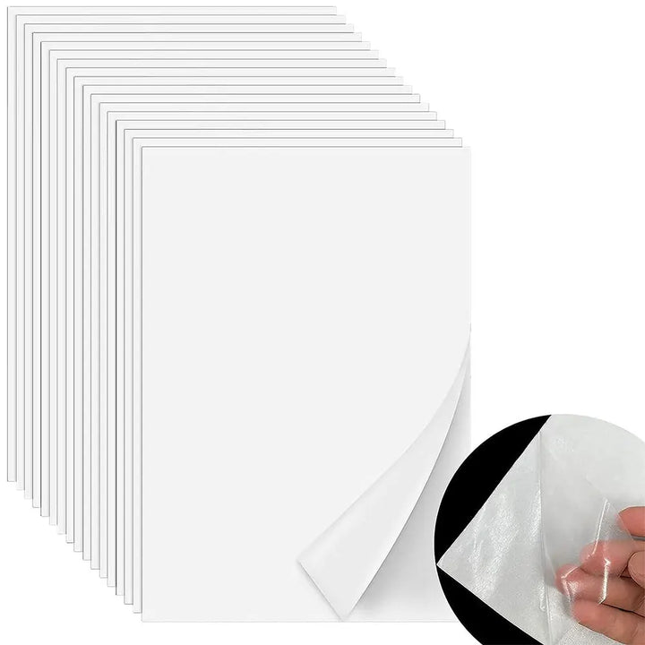 Set of clear plastic adhesive sheets with a hand holding one sheet on a white background