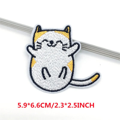 Embroidered patch of a cat on a white background with size text