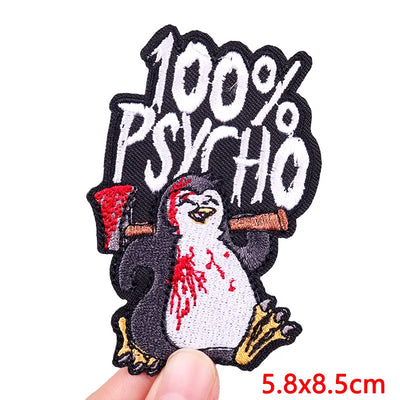 Embroidered patch with a penguin and '100% Psycho' text on a white background