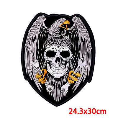 Skull with wings and tools design on a black background, size 24.3x30cm.