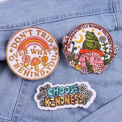 Three motivational patches on a denim background