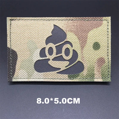 Camouflage patch with a cartoon poop emoji on a dark background