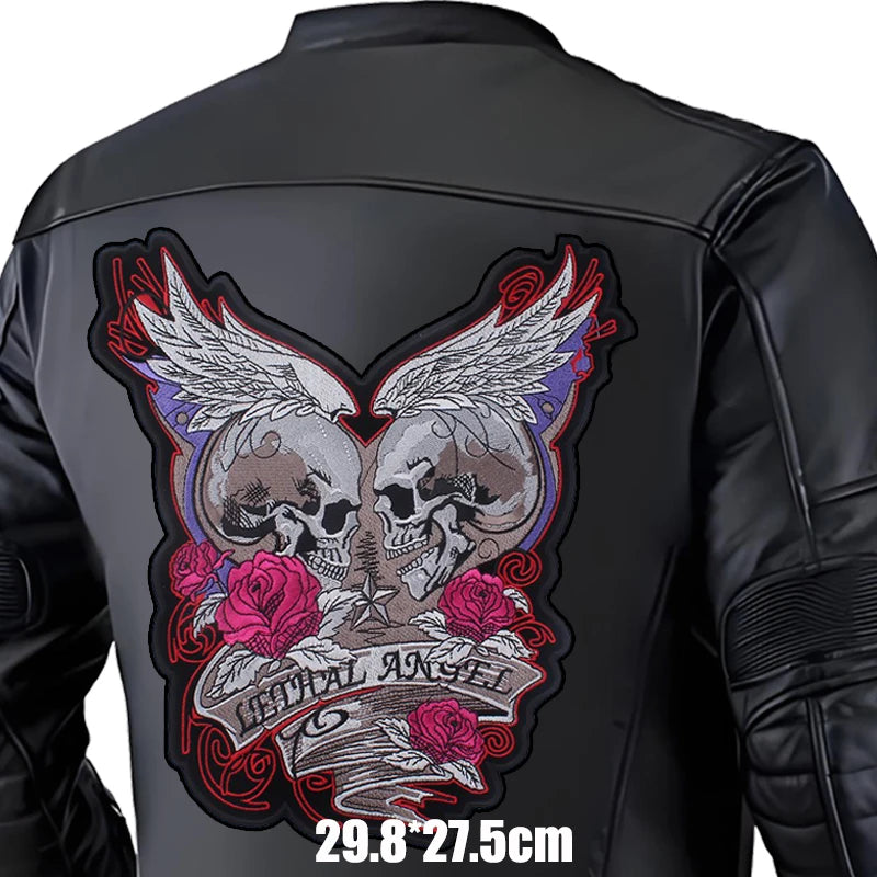 Black leather jacket with a detailed skull and wings design on the back, featuring roses and text.