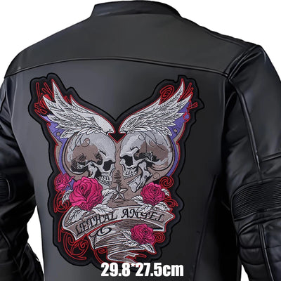 Black leather jacket with a detailed skull and wings design on the back, featuring roses and text.