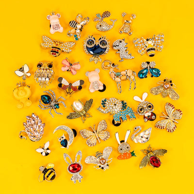 Collection of various shoe charms on a yellow background