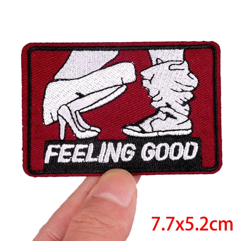 Patch with 'Feeling Good' text held by a hand, on a white background