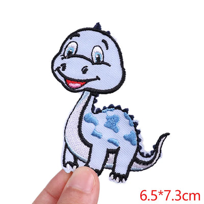 Small dinosaur patch held by a hand with dimensions displayed