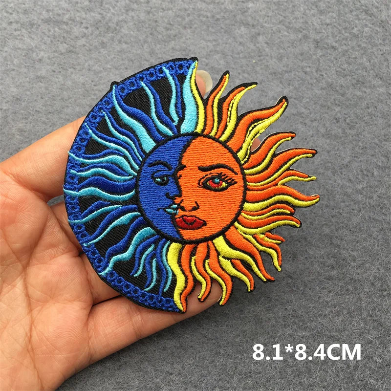 Sun and moon patch held in hand with gray background