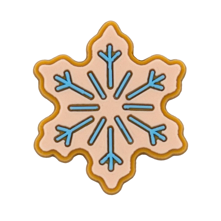 Shoe charm ornament of Decorative cookie shaped like a snowflake with blue and pink design on a white background
