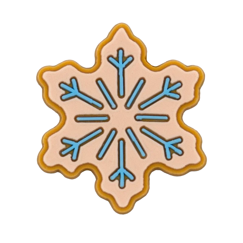 Shoe charm ornament of Decorative cookie shaped like a snowflake with blue and pink design on a white background