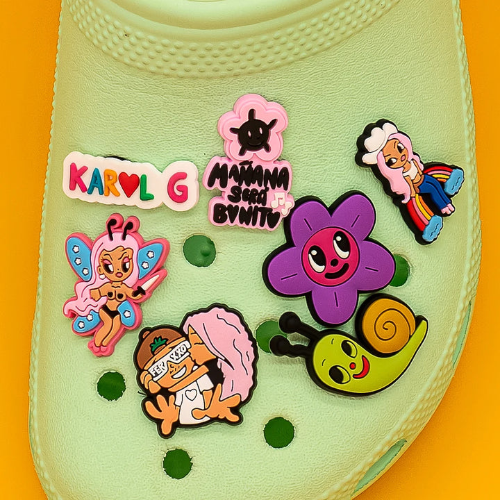Collection of colorful cartoon character shoe charms on a yellow background