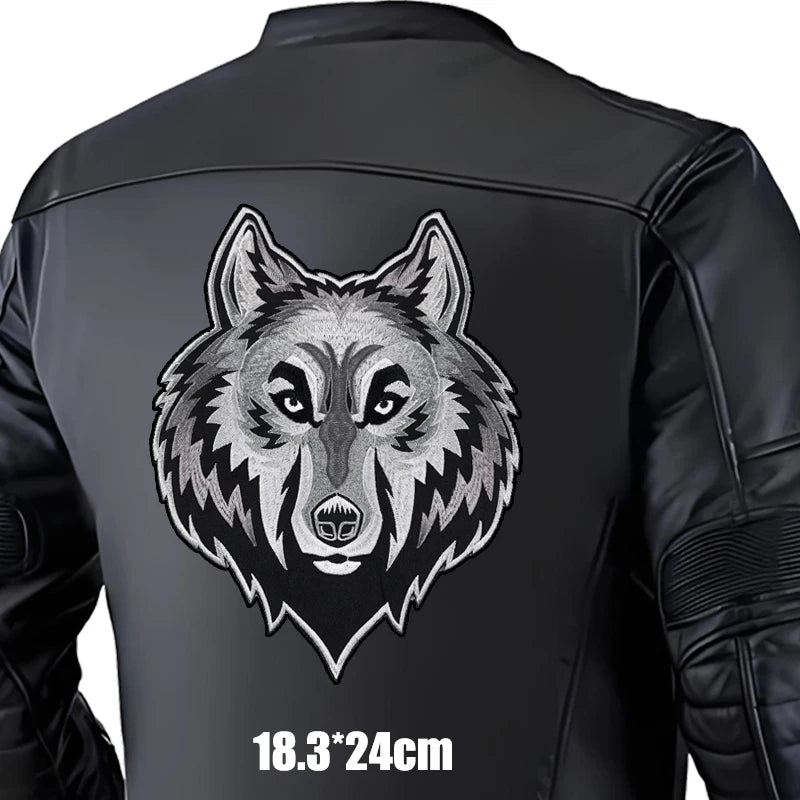 Black leather jacket with a wolf design on the back, size indicated.