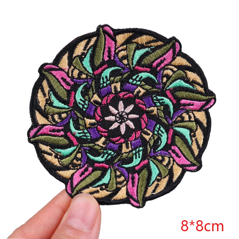 Colorful embroidered patch held by a hand with dimensions indicated.