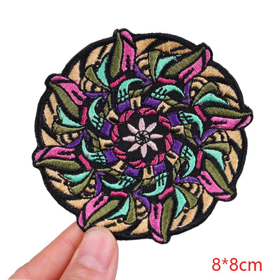 Colorful embroidered patch held by a hand with dimensions indicated.