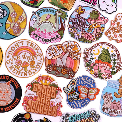 Collection of colorful embroidered patches with various designs and text.