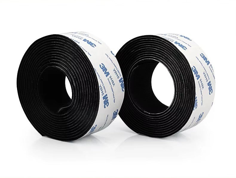 Two rolls of 3M black Velcro tape on a white background