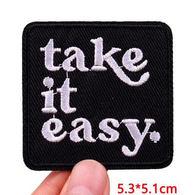 Black patch with 'take it easy' text held by a hand, size 5.3*5.1cm