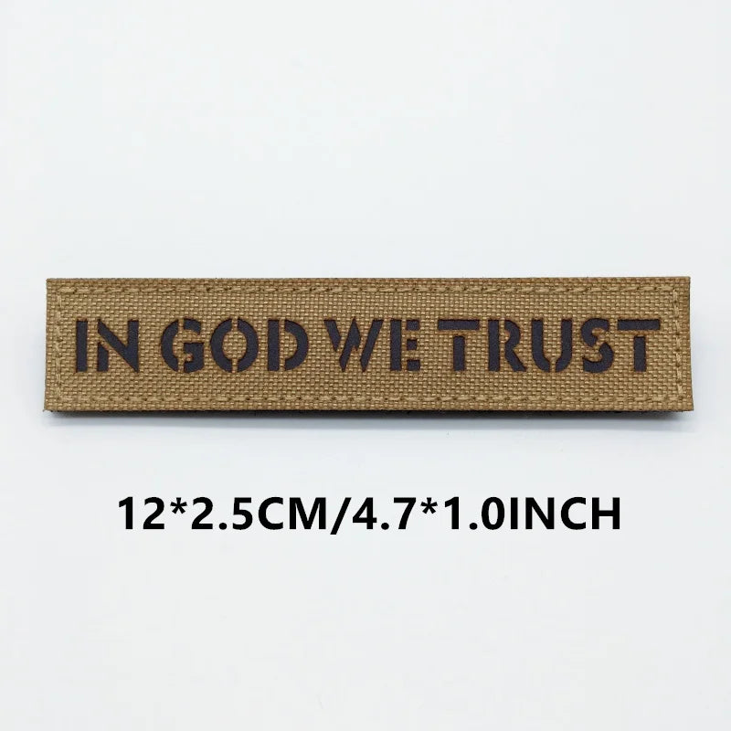 Textile patch with 'IN GOD WE TRUST' on a white background