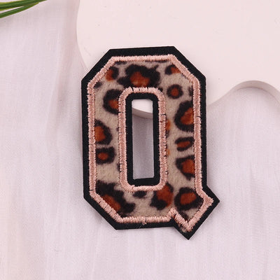 Leopard print letter 'Q' patch on a white background