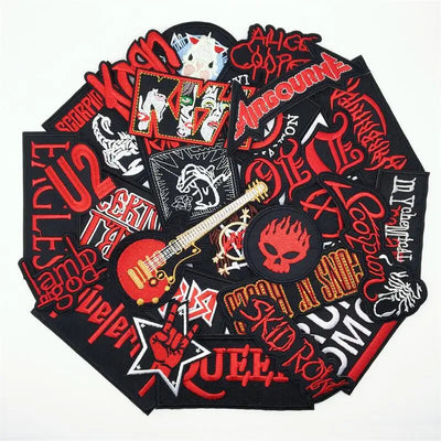 Collection of rock and roll-themed patches with various designs and text on a white background.